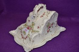 An antique cheese dish having hand tinted swags and roses pattern with gilt detailing.