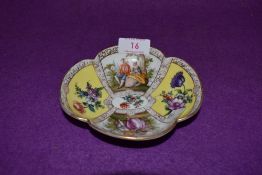 A porcelain pin dish or saucer bearing a Dresden style mark to base