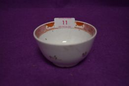 An antique ceramic tea bowl having iron red glaze