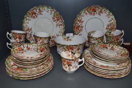 An antique part tea service by Sutherland china having green and red colour way