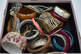 A large selection of costume jewellery bangles including, wood, plastic, metal etc