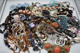 A large selection of costume jewellery necklaces including glass beads, simulated pearls, cord etc