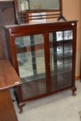 A reproduction mahogany display cabinet having internal glass shelves