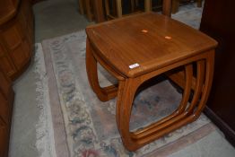 A vintage teak Nathan nest of three tables, of stylised form