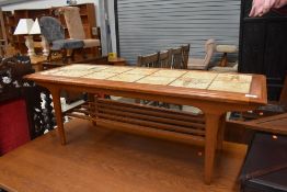 A mid century tile top table having under rack, approx. 116 x 42cm