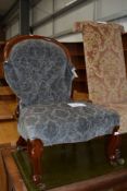 A Victorian ballon back nursing chair on knurl legs , having later upholstery