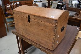 An antique pine chest having curved plank top and dovetail sides 68cm wide 39cm deep