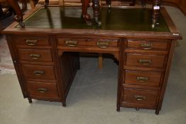 A late Victorian mahogany desk in the Aesthetic style, later skiver leather top and mounted on