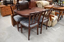 A reproduction Regency dining table and four chairs