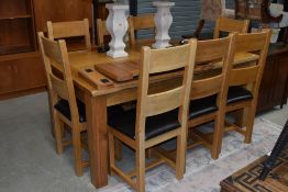 A top quality modern solid golden oak dining table and set of eight matching ladderback chairs,