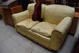An early 20th Century dropend settee having later damask style loose cover, width approx. 183cm