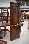 A modern reproduction regency corner display, with cupboard under