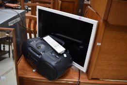 A Sharp television set with remote and Hitachi boom box