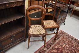 Two cane seated hall way chairs one having balloon back