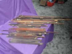 A collection of vintage Gun Cleaning Rods with mixed heads and handles, brass fittings, mixed woods,