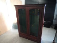 A mahogany and glazed free standing upright Gun Cabinet, spaces for 9 guns and three drawers