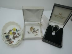 A cubic zirconia pendant in white metal mount stamped 925 on a silver chain with matched CZ