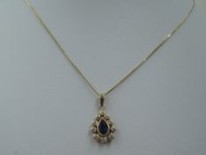 A sapphire and diamond teardrop cluster pendant in a yellow metal mount, marks worn, probably 18ct