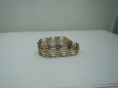 A 9ct gold six bar bracelet having twist bar decoration and padlock clasp, GW approx 14.3g