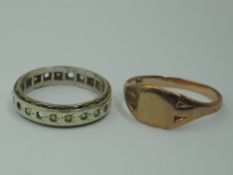 A yellow metal eternity ring stamped 9ct having cubic zirconia stones (af) and a rose gold signet