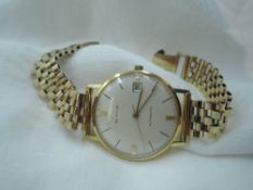 A gents Marvin automatic 18ct gold wrist watch,no:90837, having a baton numeral dial with date