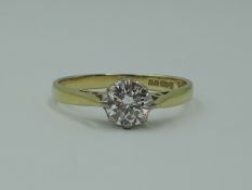 A lady's diamond solitaire dress ring, approx 0.75ct in a claw set mount to raised shoulders on an