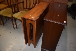 A mid century teak drop leaf dining table