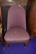 A traditional nursing chair on cabriole legs