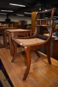 A Regency style mahogany rail back chair having later canework seat