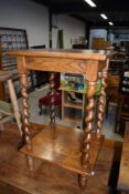 An Edwardian side or hall telephone table having twisted legs with solid oak frame