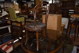 An Edwardian steam bent wood chair having decorated seat