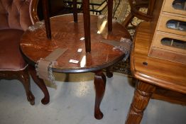 A small circular side or tea table having cabriole legs standing at 46cm high