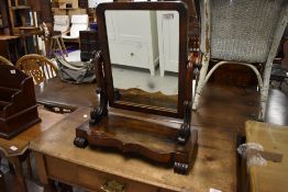 A Victorian toilet mirror having scroll work and mahogany veneer