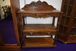 A traditional oak buffet sideboard having frieze drawers to undershelf with carved 'Greenman'