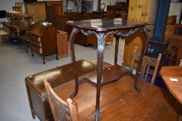 A 1920s mahogany occasional table having shaped top and undertier, width approx. 70cm