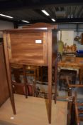 A mahogany bed side table having tapered legs with inlayed detailing