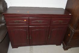 A modern laminate side board with three drawers and under cupboards