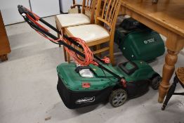 Two modern garden lawn mowers an electric Qualcast and similar Suffolk Punch barrel or cylinder