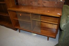 A glass fronted teak or sapele bookshelf H68cm x W108cm x D28cm