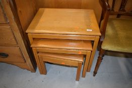 A modern light hard wood nest of three tables