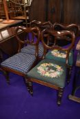 A set of four Victorian balloon back dining chairs