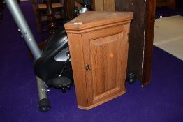 A small natural pine corner cupboard