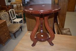 A small wooden plant stand or side table