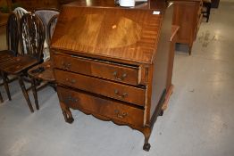 A mid century bureau having three under drawers