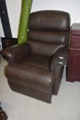 A brown leather style easy chair recliner
