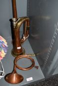 A selection of copper and brass horns including post carriage and bugle