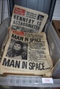 A box full of vintage newspapers.
