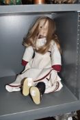 A modern ceramic limbed doll stamped made in England to neck base