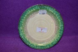 An Art Deco cake plate by Clarice Cliff in a green glaze