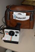 A vintage Polaroid land camera 1000 with red button, Polaroid case , warranty voucher for SX-70 film